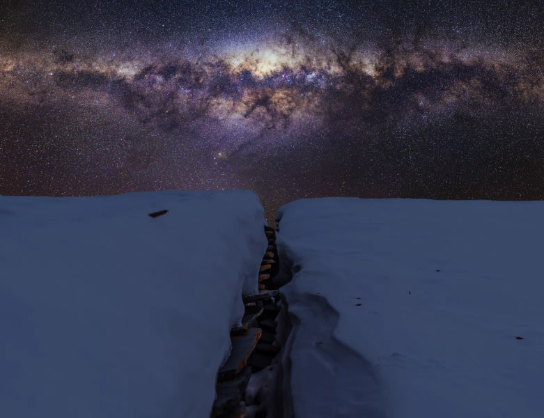 Beautiful night skies above snow-covered cliffs