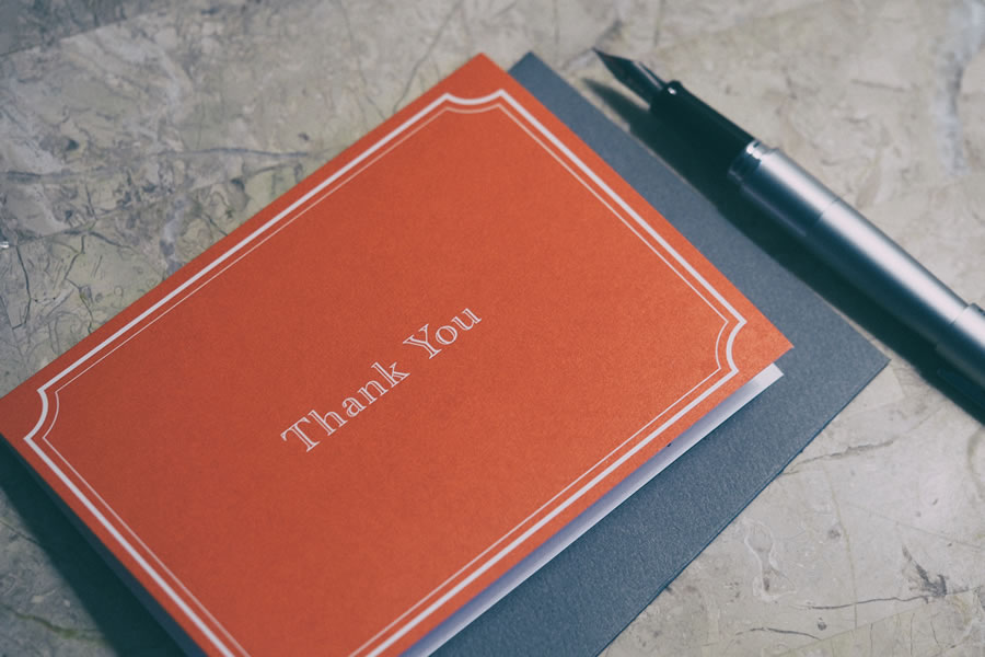 Thank-you pad and pen set on table