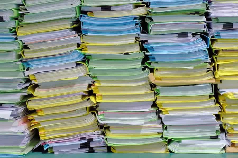 Stacks of paperwork, binders and folders